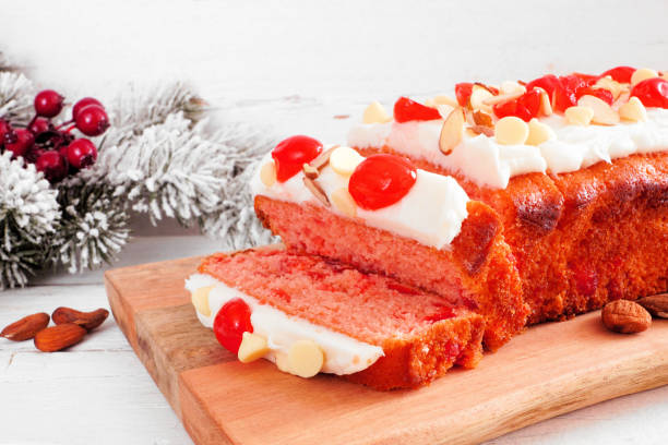 Christmas cherry loaf. Sliced, close up against a white table scene background.
