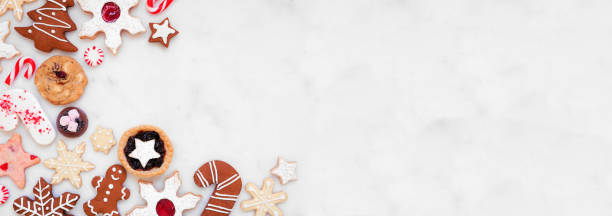 istock Christmas baking corner border with assorted cookies and sweets on a white marble banner background 1750540334