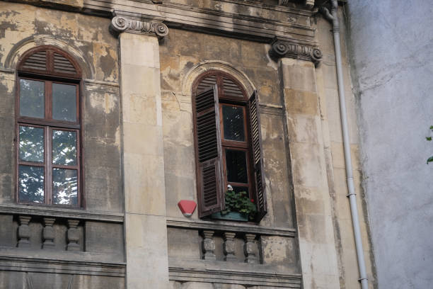 istock stone house with open wooden window 1750555102