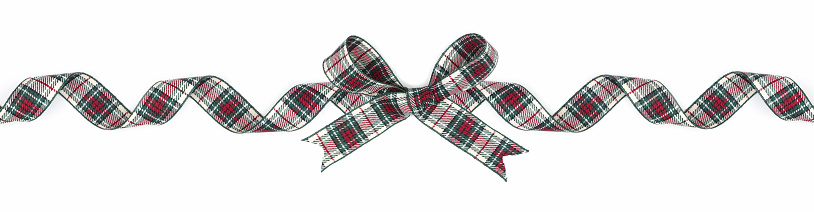 Green, red and white plaid Christmas gift bow and ribbon. Long border, curled, isolated on a white background.