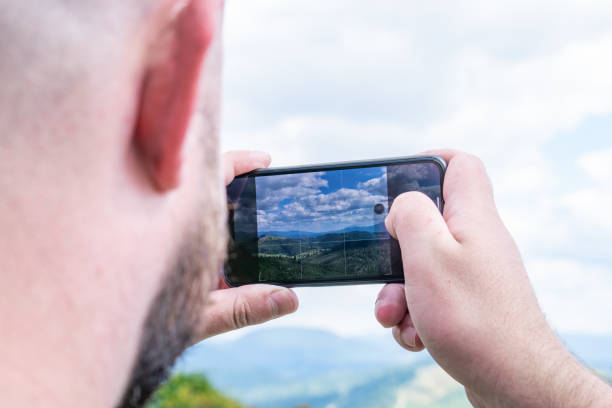 Traveler takes photo on smartphone. stock photo