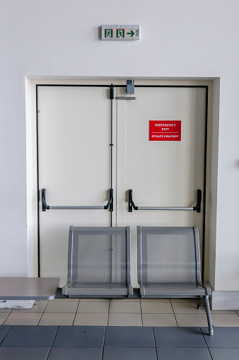Blocked emergency exit fire door in a Greek airport preventing people getting out in the event of an emergency.