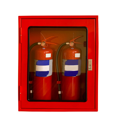 Two wall-mounted fire extinguishers in an easily accessible case. Mounted on the wall of an indoor office on a white background with clipping path.