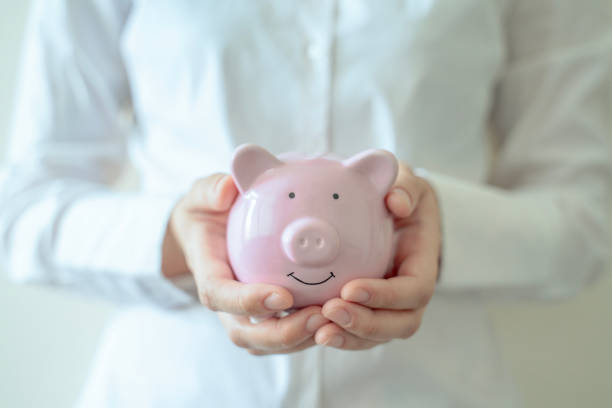 istock Holding piggy bank 1750635706