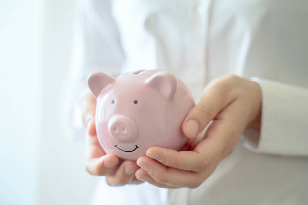 istock Holding piggy bank 1750637303