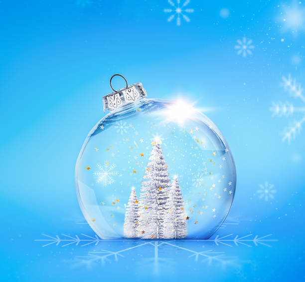 istock transparent Christmas ball with silver Christmas trees inside on a blue background with snowflakes 1750657301