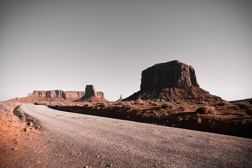 A dirt road through Monument Valley along the border of Arizona and Utah, USA.