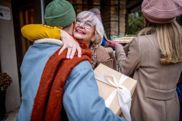 Mother hugging her son on a Christmas arrival at home