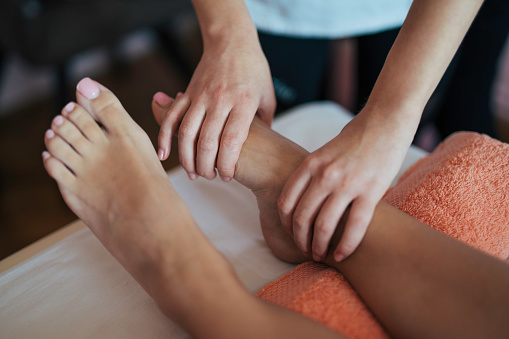 Beautician giving a client a relaxing foot massage