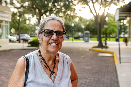 This is a close up portrait of a Puerto Rican woman in her 70s smiling and looking at the camera in Winter Park, Florida.