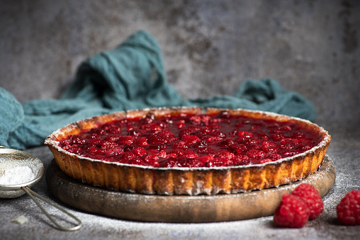 Homemade Traditional berry pie in a frying pan, sweet baked pastry food on rustic wooden table, top view