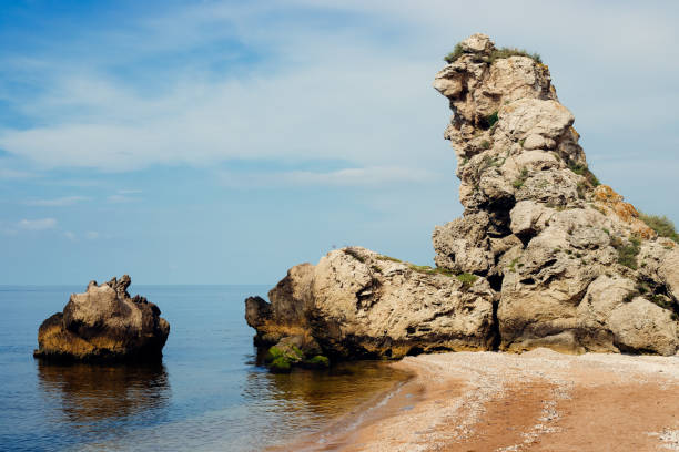 istock Rocky seashore with a bizarre rock and stones. Seascape 1750753762