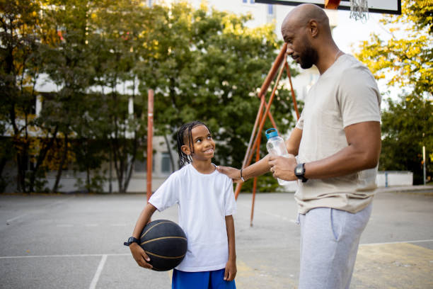 istock Boy and his father taking a break while playing basketball 1750758259