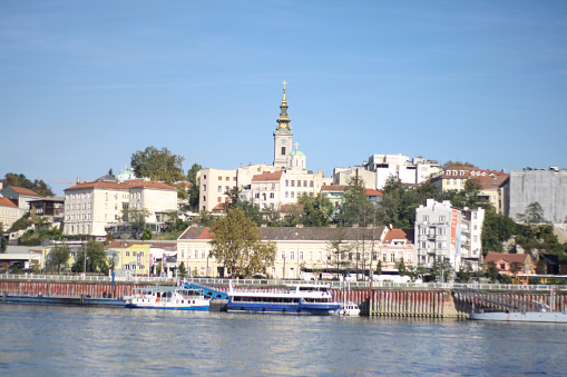 a small boat sails on the Sava River in the waterfront Belgrade neighborhood