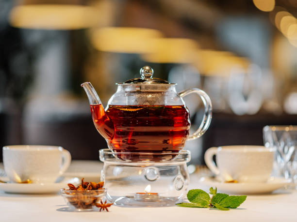 istock Glass teapot with warmer on table in restaurant 1750779611