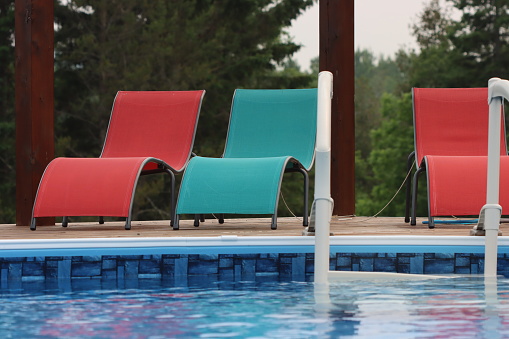 Lounge chairs alongside outdoor pool