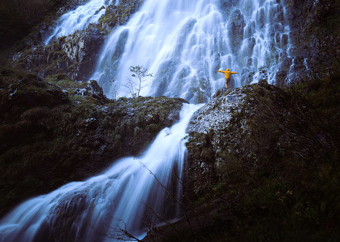 Ordu Çağlayan Şelalesi. Free and brave person with waterfall and yellow raincoat. Türkiye is also known as 