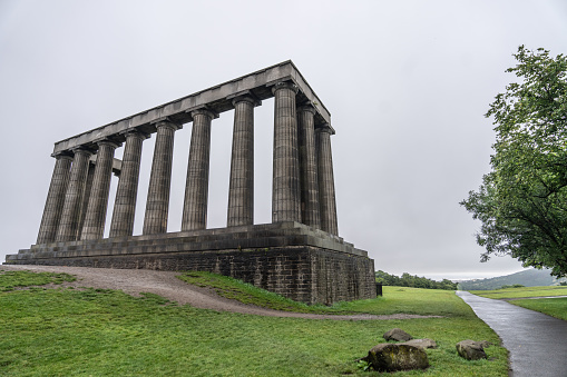 looking up at the National Monument of Scotland on Calton Hill, Edinburgh, Scotland on a gloomy day