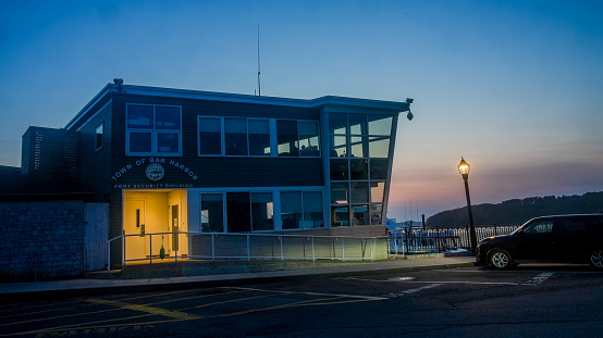 Bar Harbor, Maine, USA - July 11, 2023: Port security building in town of Bar Harbor with evening lights