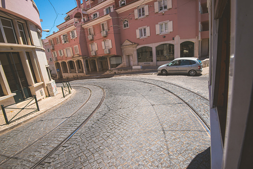 Lisbon, Portugal - July 21 2016: Sharp corner of a street with tram tracks.