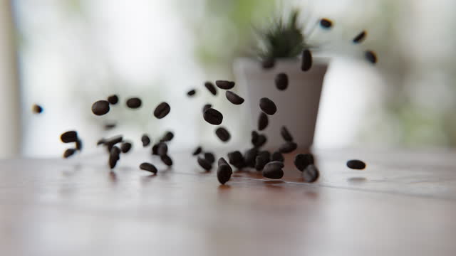 Coffee beans falling on and bouncing off of the wooden table in a 3D animation