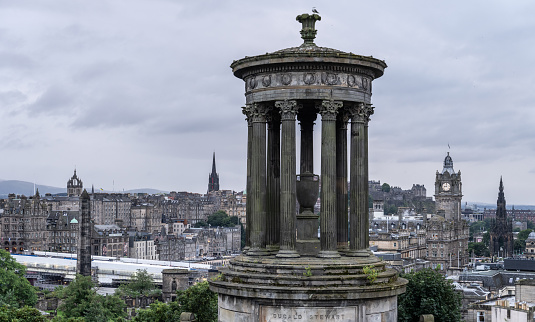 view of Dugald Stewart Monument from Calton Hill with Edinburgh, Scotland in the background