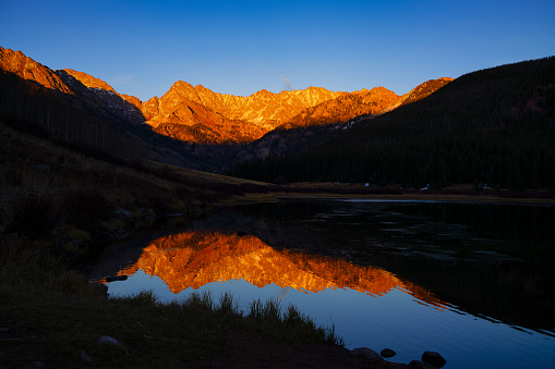 Piney Lake at Sunset - Gore Range Mountains with Peak C and Mt. Powell captured with late afternoon warm sunlight during late autumn. Vail, Colorado USA.