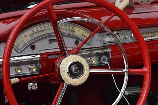 Fresno, United States – October 15, 2023: This image captures the interior of a classic red car with vintage-style gauges