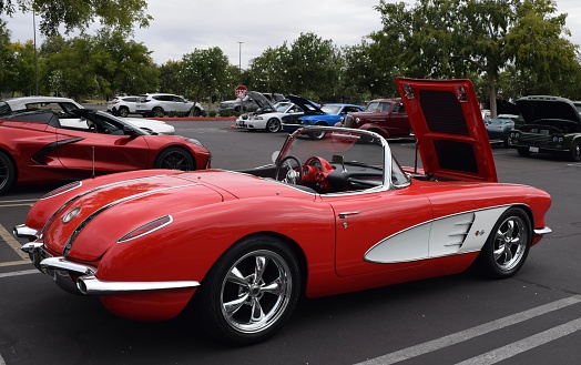 Fresno, United States – October 15, 2023: Classic red Corvette Convertible at a classic car show in parking lot outside with front hood up