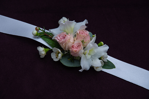 Wedding bouquet of white roses and buttercups on a wooden table. top view.