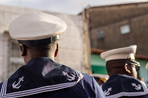 Saubara, Bahia, Brazil - August 06, 2022: Men from a Marujada, dressed as sailors, are seen parading through the streets of the city of Saubara, in Bahia.