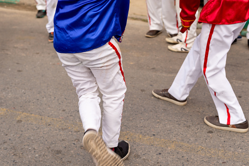Saubara, Bahia, Brazil - August 06, 2022: Low view of members of a Marujada performing through the streets of the city of Saubara, in Bahia, during the Chegancas meeting.