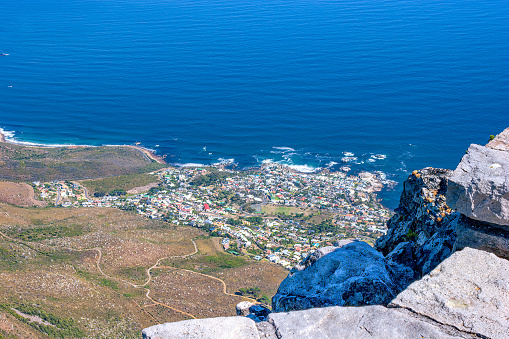 The town of Camp's Bay as viewed from Table Mountain in Cape Town, South Africa. Photo shot in the afternoon sunlight; horizontal format.  Copy space.