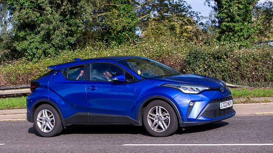 Milton Keynes,UK - Oct 22nd 2023: 2022 blue hybrid electric Toyota C-HR   car on an English road