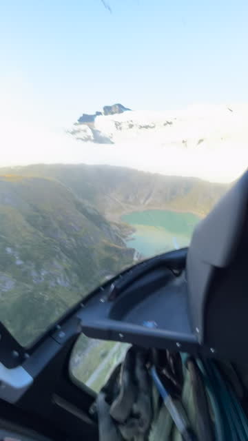 POV flying in helicopter over the alps