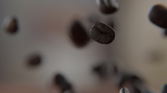 Close up of Coffee beans falling on and bouncing off of the wooden table