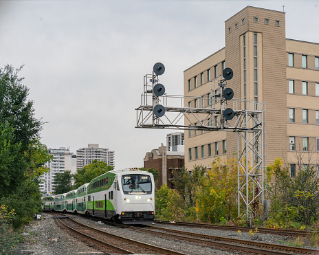 Railway System through a City Center with a Passenger Train arriving  in Hamilton, Ontario