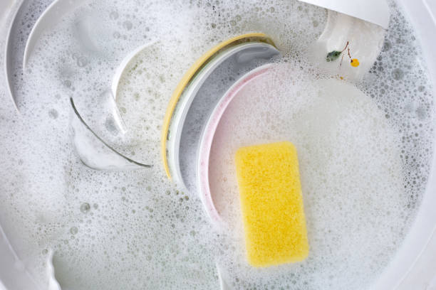 istock Dishes and bowls in water and bubbles of dishwashing liquid. Kitchen work 1751036201
