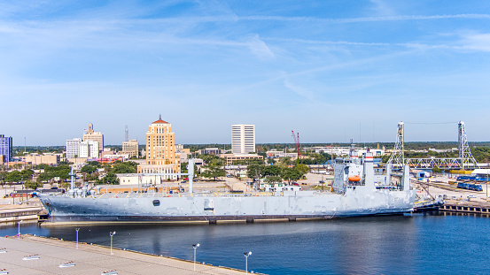 Aerial view or the Port of Beaumont Texas with the Downtown District Cityscape, A freight Train, modern and historic buildings with a blue sky and copy space.