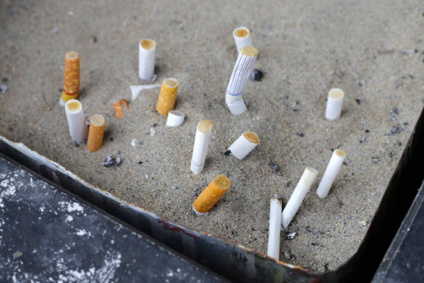 istock Cigarettes and ash on dirty sand in trash tray 1751045686