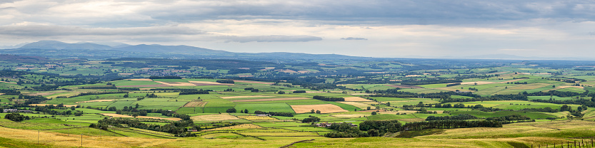 panoramic view across the Cumbrian countryside from the North Pennines Area of Outstanding Natural Beauty (AONB), UK