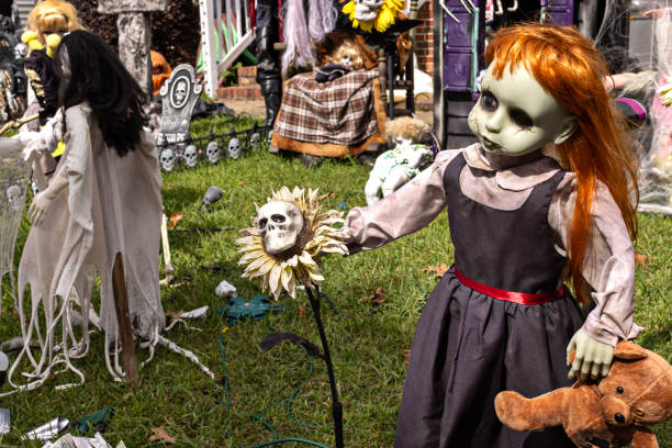 Halloween yard with highlight being a spooky doll holding a teddy bear