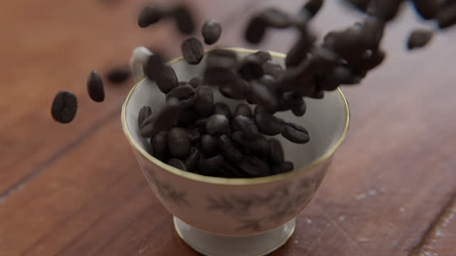 Close up rotating shot of Coffee beans falling into a cup in slow motion