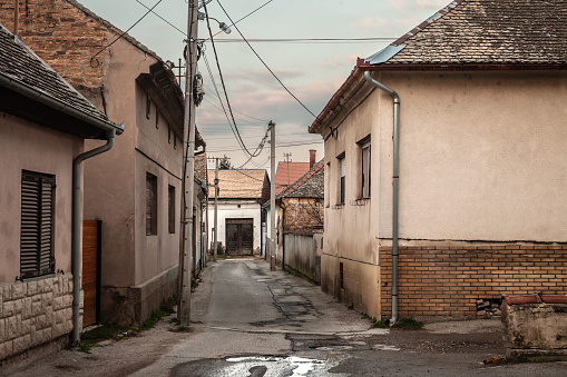 Picture of a typical street of Vojvodina, in Serbia, in Central Europe, in sremski karlovci, made of individual houses and buildings, decayed, in a deserted empty street.