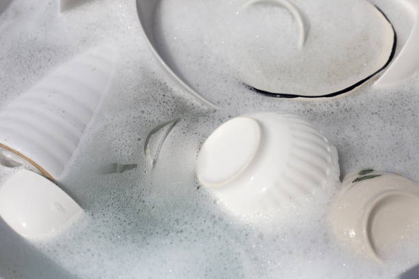 istock Dishes and bowls in water and bubbles of dishwashing liquid. Kitchen work 1751097035