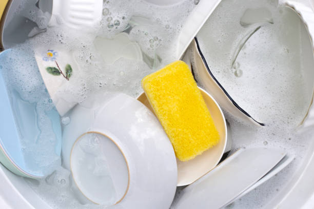istock Dishes and bowls in water and bubbles of dishwashing liquid. Kitchen work 1751097553
