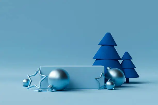 Blue Christmas background with felt Christmas tree, baubles, stars and copy space.