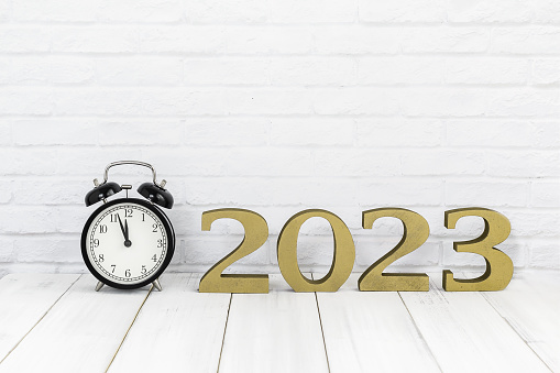 2023 new year & alarm clock on white wood table over white background with copy space , time concept
