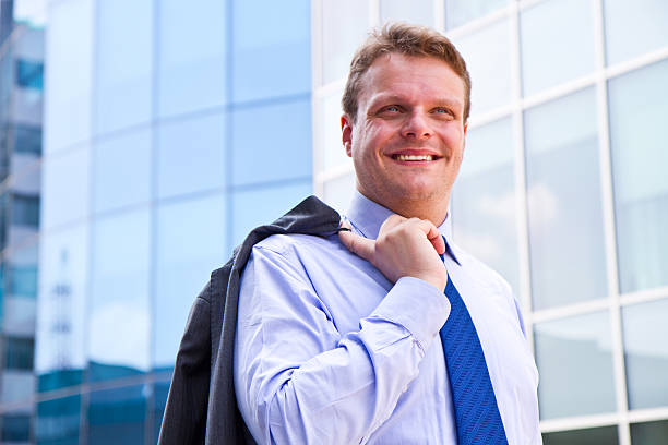 istock Smiling businessman standing outside a building 175113210