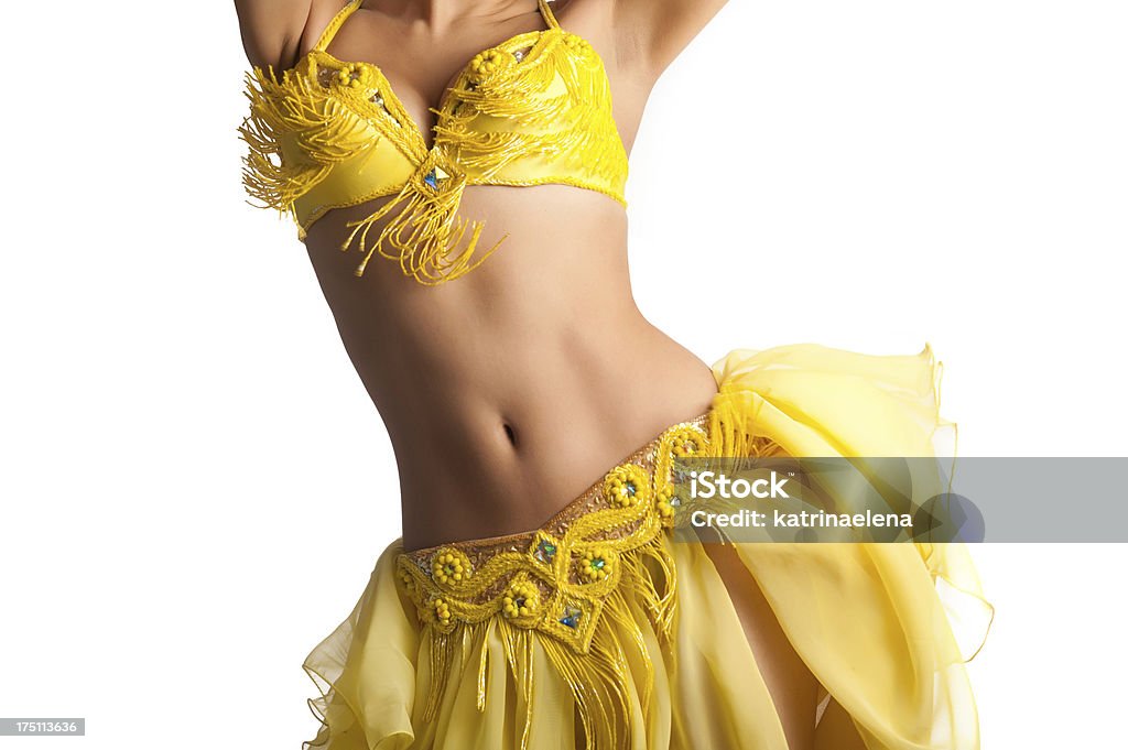 Bellydancer with Yellow Costume Shaking Her Hips Torso of a female belly dancer wearing a bright yellow costume and shaking her hips. Isolated on white. Belly Dancing Stock Photo